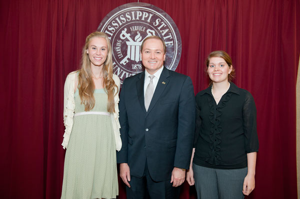Dr. Keenum stands with student award winners from the President's Commission for the Status of Women.