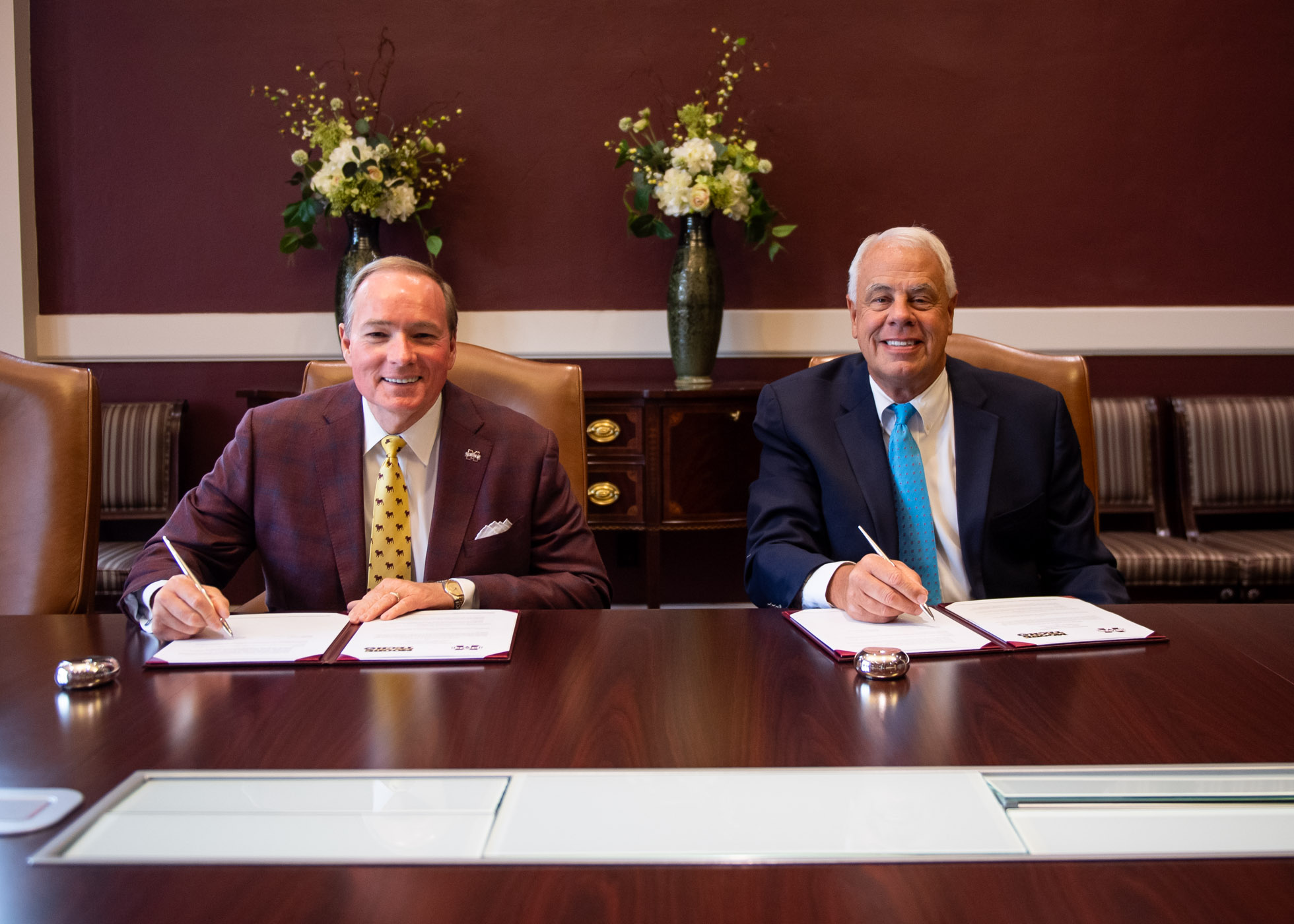 MSU President Mark E. Keenum, left, and Moore Tech President Skip Redmond sign a memorandum of understanding Thursday [Aug. 24] 