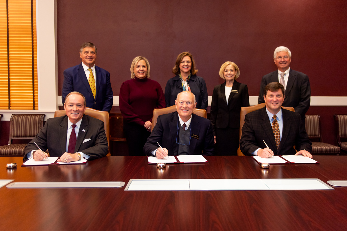 MSU President Mark E. Keenum, seated left, joined Luckyday Foundation Board Chair Jamie Houston and MSU Vice President for Devel