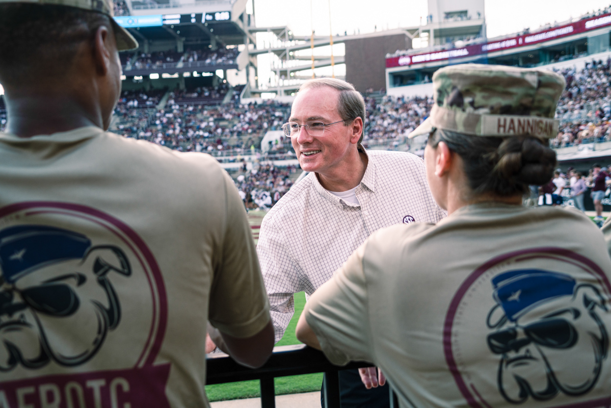 President Keenum smiles and shakes the hands of AFROTC cadets at Davis Wade.