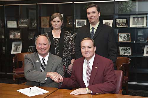 Presidents Rick Young of EMCC (l) and Mark Keenum recently marked the formal participation of the community college in the Golden Triangle Regional Library Consortium.