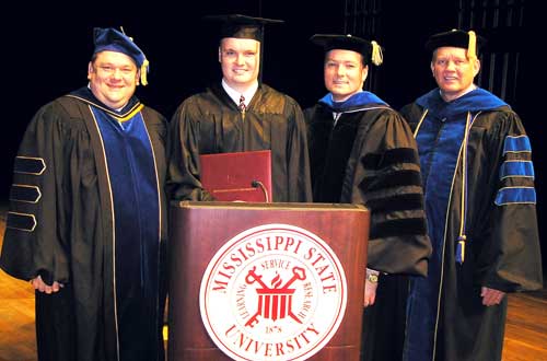 Gary Wayne Pace of Bailey (2nd from left) made history during Friday's Mississippi State University-Meridian commencement ceremonies when he became the first graduate to earn a degree from MSU-Meridian's newest degree program--bachelor of business admini