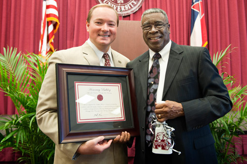 Keenum presents Dr. Weary with an honorary degree and a cowbell at the MLK Jr.
