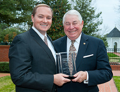 Mississippi State President Mark E. Keenum, left, presents Richard Adkerson with the distinction of Alumnus of the Year on behalf of university's Alumni Association.
