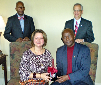 Mississippi State University First Lady Rhonda Keenum, seated left, presented His Excellency Elkanah Odembo, the Kenyan Ambassador to the U.S., seated right, with a commemorative MSU cowbell following a luncheon in Odembo's honor on Thursday in the Swalm