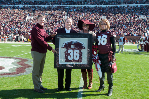 Dr. Keenum and Scott Stricklin present Nick Bell's jersey to his family for Senior Day.