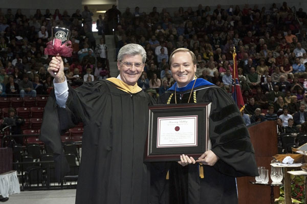 Governor Phil Bryant accepts an "Honorary Bulldog" certificate from Dr. Mark Keenum during December 2012 Commencement.
