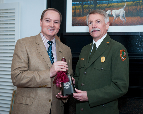 MSU President Mark E. Keenum presents a cowbell to National Park Service Director Jon Jarvis during his visit to campus.