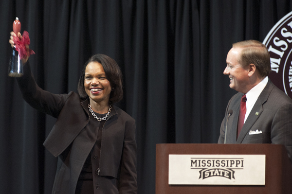 Former U.S. Secretary of State Condoleezza Rice shows off her Bulldog spirit as she receives a cowbell from MSU President Mark E. Keenum.