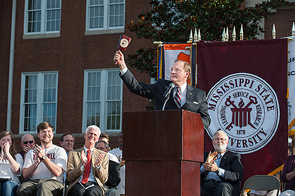 MSU President Mark E. Keenum rings a cowbell during the Drill Monday night.