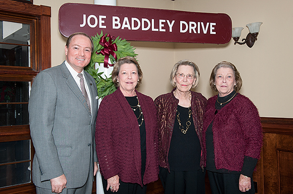 During the Tuesday rededication ceremony for Joe Baddley Drive at the adjacent A.B. McKay Food Research and Enology Laboratory, President Mark E. Keenum presented former signage marking the road to members of the Baddley family.
