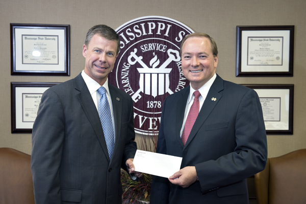 Mississippi State University President Mark E. Keenum, right, recently received a charitable contribution from Cadence Bank, which was presented by Jerry Toney, bank president for Mississippi.