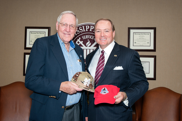 Jack Winstead, a board member of Friends of Mississippi Veterans (FMV), presented Mississippi State University president Mark E. Keenum with a FMV cap and received a MSU camo baseball cap from the president.
