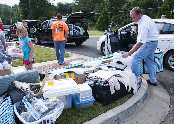 MSU President Mark E. Keenum was one of many volunteers who helped incoming freshmen carry their belongings into their new residence halls on the university's annual move-in day, known as "MVNU2MSU." The Department of Housing and Residence Life saw about