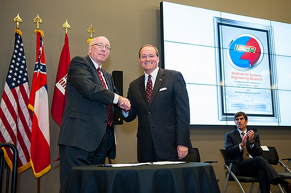 Jeffery P. Holland (l-r), director of the U.S. Army’s Engineer Research and Development Center in Vicksburg, and MSU President Mark E. Keenum celebrate the signing of an agreement establishing the Institute for Systems Engineering Research Thursday aft