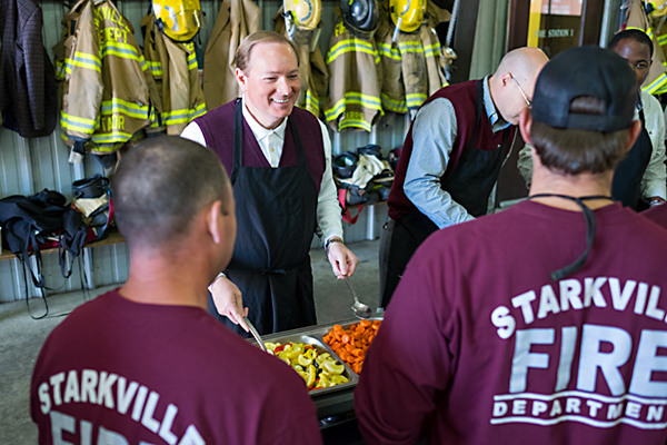 MSU President Mark E. Keenum serves members of the Starkville Fire Department during the Thanksgiving lunch held Friday [Nov.