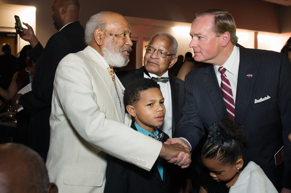 Mississippi State University President Mark E. Keenum, right, greets Mississippi civil rights pioneers James Meredith, left, and Dr. Richard Holmes, center, during Black Alumni Weekend gala activities at The Mill at MSU. Meredith and Holmes were the firs