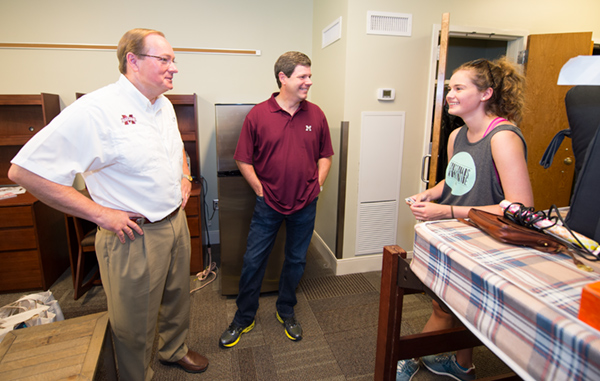 MSU President Mark E. Keenum, left, visits with Natalie L. Wilson, a freshman interior design major from Biloxi, along with her father Anthony Wilson, during MVNU2MSU. Natalie was among hundreds of students who moved into campus residence halls August 6 