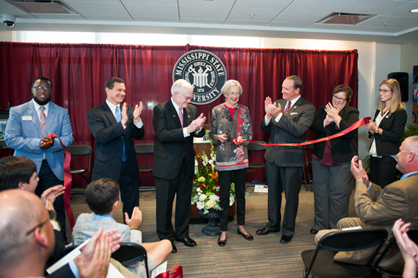 Mary Ann Deavenport cuts the ribbon during the dedication ceremony for Earnest W. and Mary Ann Deavenport Hall on Oct.