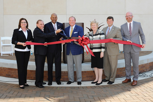 Celebrating a ribbon-cutting ceremony for the new Riley Campus Courtyard in downtown Meridian Aug.
