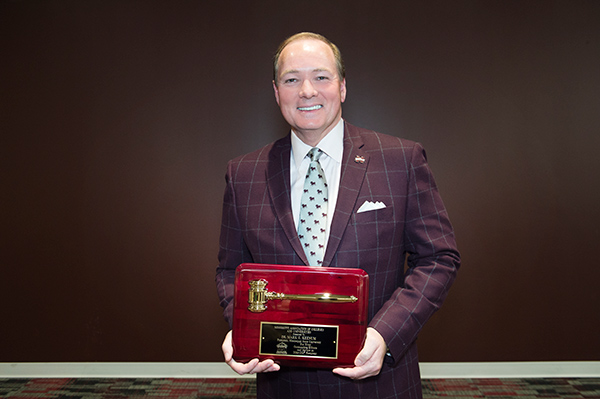 MSU President Mark E. Keenum holds a plaque commemorating his service as president of the Mississippi Association of Colleges and Universities.