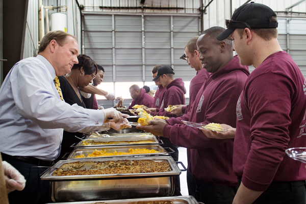 Mississippi State University President Mark E. Keenum, left, along with MSU Dining Services, served up a Thanksgiving feast in November to the Starkville Fire Department.