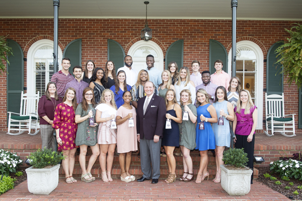 MSU President Mark E. Keenum (front row, center) enjoyed a recent visit at his home with the university’s Orientation Leaders