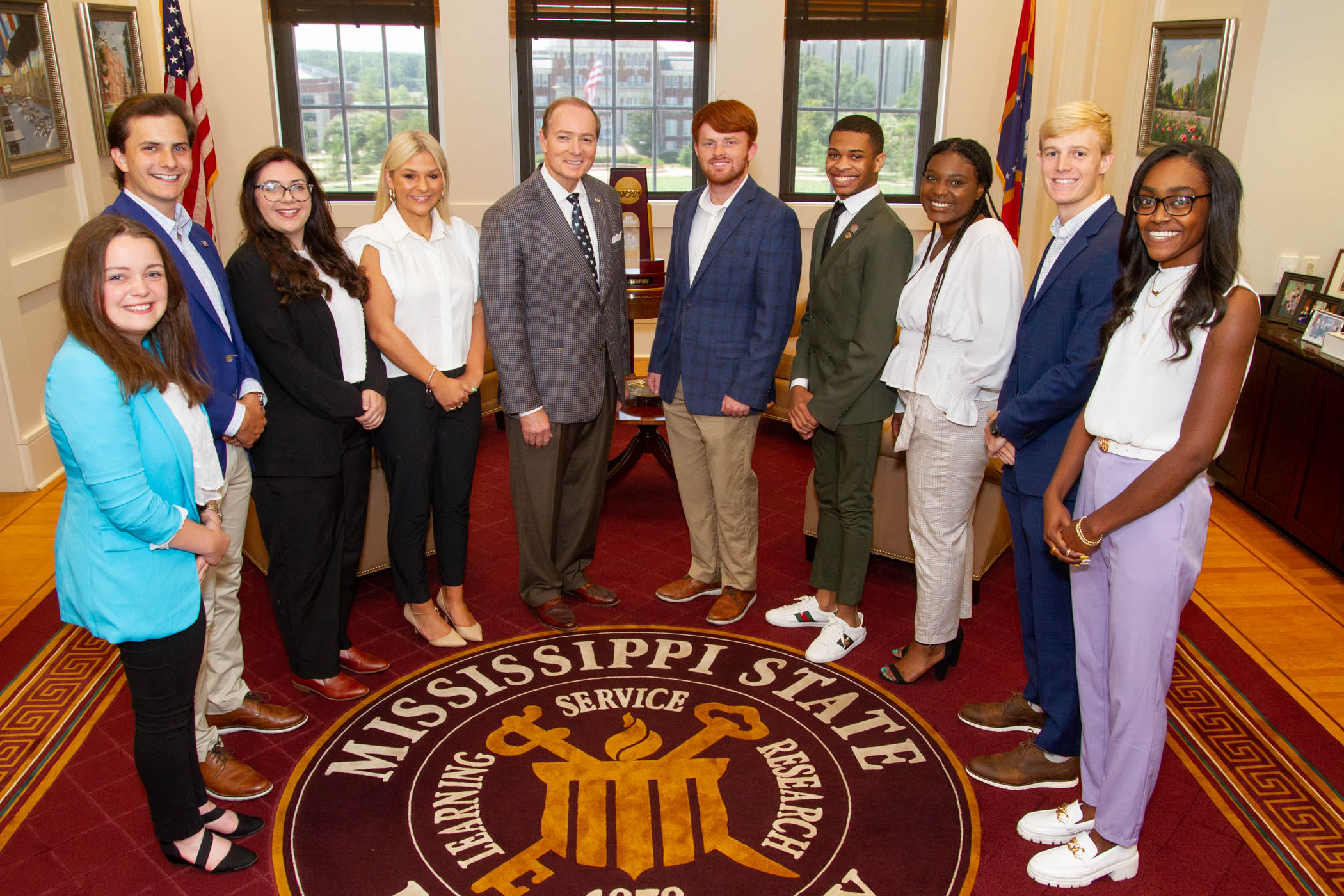 President Keenum and Student Association Officers gather around the university seal for a photo