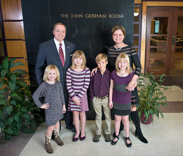 The Keenum family in front of the John Grisham Room at the Mitchell Memorial Library.