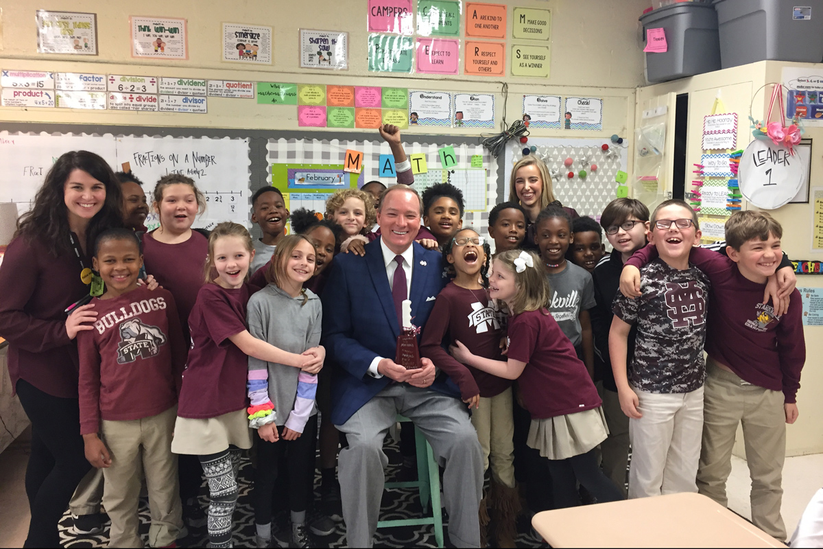 President keenum is surrounded by local school children after reading to them in a Ward Stewart classroom.