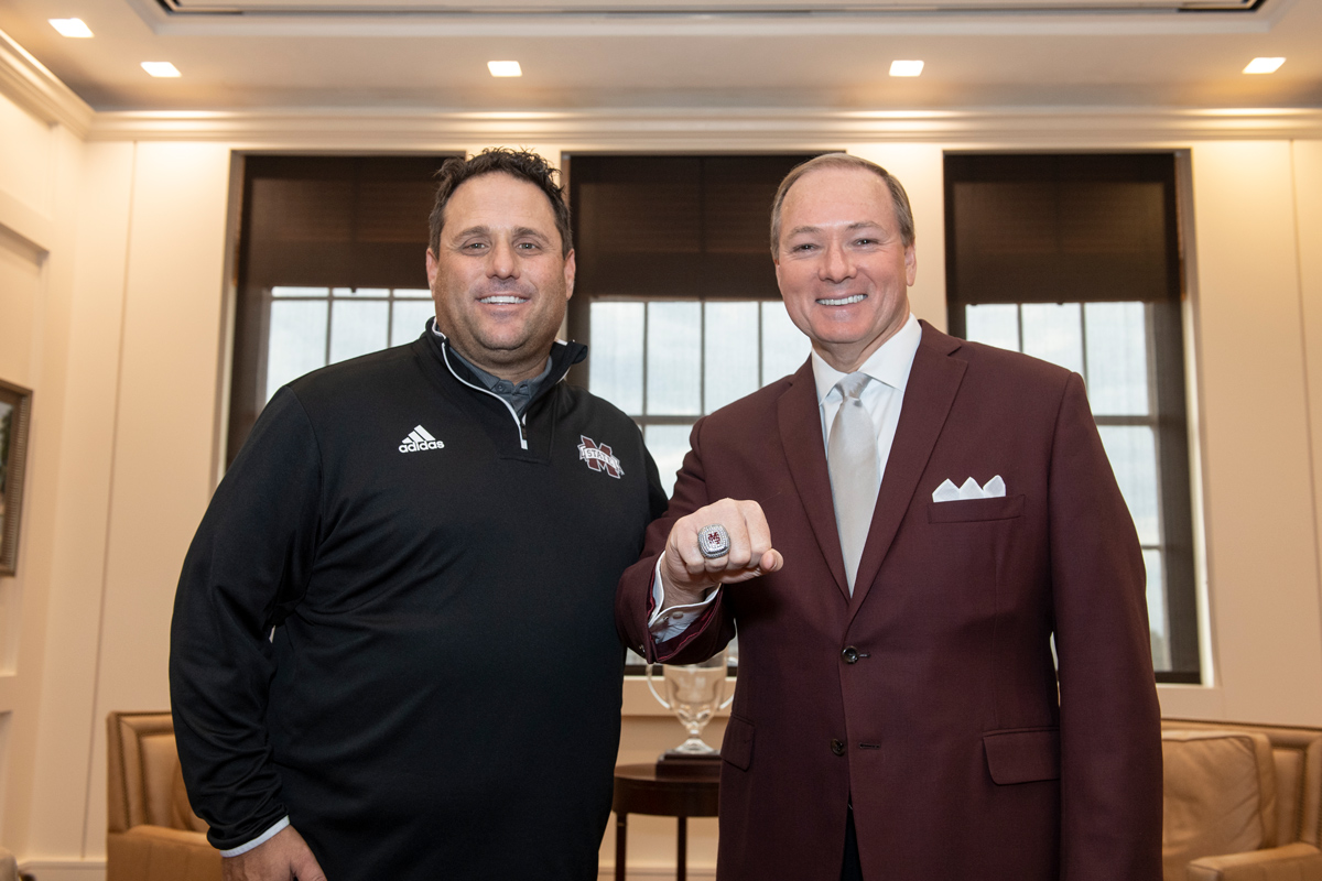 MSU head baseball coach Chris Lemonis presents MSU President Mark E. Keenum with the 2019 CWS ring.