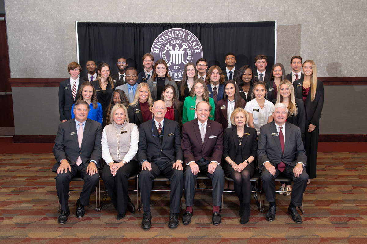Group photo with President Keenum and Luckyday board members seated in front and 24 Luckyday Scholars behind.