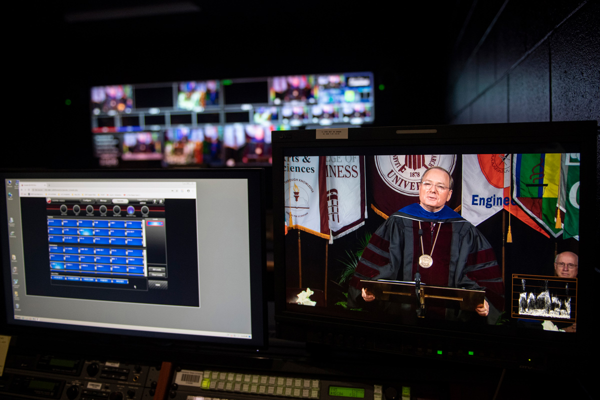 Inside the control room of the MSU Television Center, President Keenum appears on screens from a range of camera angles.
