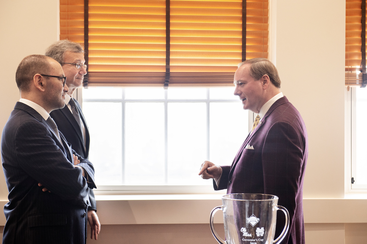 With the window behind them, President Keenum talks with the Ambassador of Uzbekistan and U.S. Ambassador to Uzbekistan. 