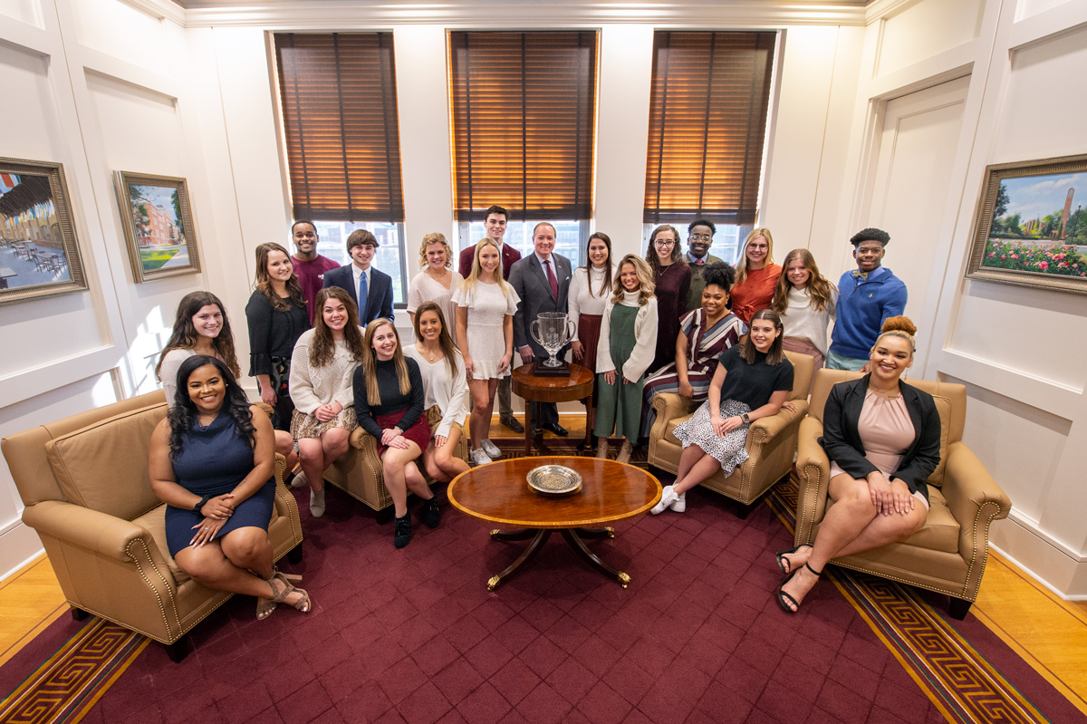 The 2020 OL students surround President Keenum in his office for a posed photo.