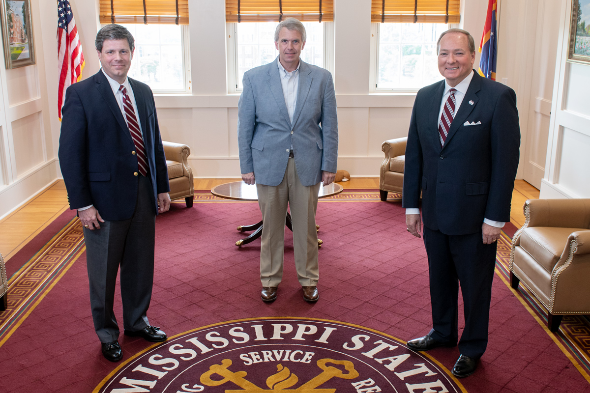 Posed left to right around MSU Seal in President Keenum's office: Anthony Wilson, Brandon Presley, and President Keenum.