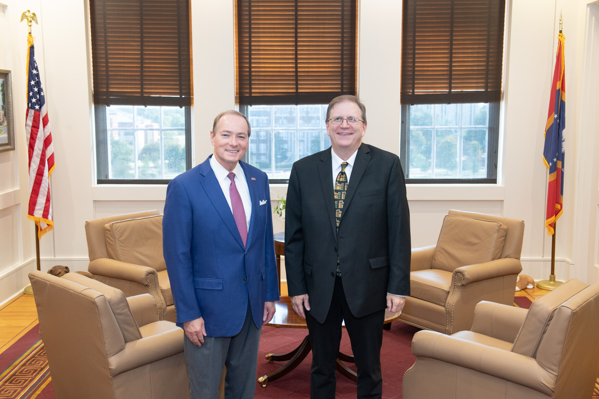 President Keenum (at left) poses for a photo with University Press of Mississippi Director Craig W. Gill.